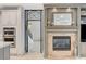 Fireplace with built-in shelving, connecting seamlessly to the kitchen through a decorative doorway at 10249 Wisteria Hills Ct, Las Vegas, NV 89135