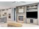 Living room features a fireplace with built-in shelving, providing ample storage and display space at 10249 Wisteria Hills Ct, Las Vegas, NV 89135
