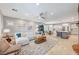 Spacious living room with a view of the kitchen, dining area, fireplace, and comfortable seating at 10249 Wisteria Hills Ct, Las Vegas, NV 89135