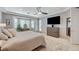 Comfortable main bedroom features a ceiling fan, media center, bay window, and neutral decor at 10249 Wisteria Hills Ct, Las Vegas, NV 89135