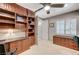 Spacious office features custom built-ins, granite countertops, and bright light from large shuttered window at 10249 Wisteria Hills Ct, Las Vegas, NV 89135