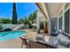 Backyard view featuring a pool, waterslide, seating area, and covered patio with ceiling fan at 10249 Wisteria Hills Ct, Las Vegas, NV 89135
