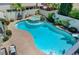 Beautiful backyard pool featuring a hot tub, custom water feature, and lush landscaping at 10249 Wisteria Hills Ct, Las Vegas, NV 89135