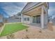 Landscaped backyard with artificial turf, gravel, a covered patio, and a privacy wall, perfect for outdoor enjoyment at 10465 Smokey Mariposa, Las Vegas, NV 89166