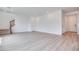 Bright and spacious living room with light wood floors and staircase access at 10465 Smokey Mariposa, Las Vegas, NV 89166