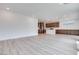 Expansive living area featuring modern light wood floors open to kitchen at 10465 Smokey Mariposa, Las Vegas, NV 89166
