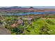 Scenic aerial view overlooking the golf course, lake, and residential area, with mountains in the distance at 12 Strada Di Circolo, Henderson, NV 89011