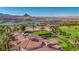 Breathtaking aerial view of the property with panoramic vistas of mountains, a lake, and a lush golf course at 12 Strada Di Circolo, Henderson, NV 89011