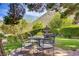 Inviting backyard featuring a stone patio, a fountain, and lush landscaping with mountain views at 12 Strada Di Circolo, Henderson, NV 89011
