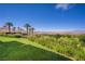 Lush backyard with a manicured lawn and vibrant flowerbeds overlooking a stunning golf course and lake at 12 Strada Di Circolo, Henderson, NV 89011