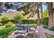 Inviting backyard featuring a stone patio, a fountain, and lush landscaping with mountain views at 12 Strada Di Circolo, Henderson, NV 89011