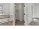 Bathroom features a soaking tub next to a walk-in closet and white walls at 12 Strada Di Circolo, Henderson, NV 89011