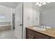 Bathroom with granite vanity top, soaking tub, and white cabinets at 12 Strada Di Circolo, Henderson, NV 89011