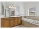 Bathroom featuring granite countertop, soaking tub and tile flooring at 12 Strada Di Circolo, Henderson, NV 89011