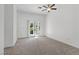Bright, carpeted bedroom features ceiling fan and patio access at 12 Strada Di Circolo, Henderson, NV 89011