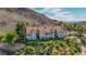 Beautiful multi-unit building with terracotta roofs and balconies surrounded by mature trees and desert landscaping at 12 Strada Di Circolo, Henderson, NV 89011