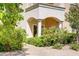 Picturesque exterior with classic columns, an arched entryway, and lush, colorful landscaping at 12 Strada Di Circolo, Henderson, NV 89011