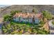 Elegant multi-story home with a tile roof, multiple balconies, and mature landscaping on a hillside at 12 Strada Di Circolo, Henderson, NV 89011