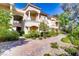 Beautiful building exterior featuring balconies, classic columns, and lush landscaping on a sunny day at 12 Strada Di Circolo, Henderson, NV 89011