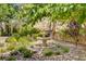 Charming three-tiered fountain surrounded by lush greenery, creating a serene and inviting garden retreat at 12 Strada Di Circolo, Henderson, NV 89011