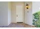 Inviting front entrance featuring a classic white door with decorative hardware and an elegant wall sconce at 12 Strada Di Circolo, Henderson, NV 89011