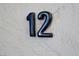 Close up of the number 12 on a stucco wall at 12 Strada Di Circolo, Henderson, NV 89011