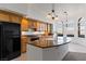 Kitchen island featuring granite countertops, a black refrigerator, and barstool seating at 12 Strada Di Circolo, Henderson, NV 89011