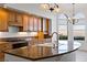 Kitchen island with granite countertops, built-in gas cooktop, and stainless sink at 12 Strada Di Circolo, Henderson, NV 89011