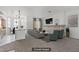 Staged living room showcasing modern furnishings, a fireplace and view of kitchen at 12 Strada Di Circolo, Henderson, NV 89011