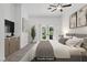 Comfortable main bedroom with neutral decor and sliding door to outdoor space at 12 Strada Di Circolo, Henderson, NV 89011