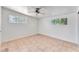 Spacious bedroom with tile flooring, ceiling fan, and natural light from two windows at 1713 E Bonanza Rd, Las Vegas, NV 89101