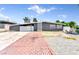 Single story home with brick driveway and desert rock landscaping in the front yard at 1713 E Bonanza Rd, Las Vegas, NV 89101