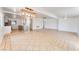 Open concept living room with modern light fixture, tile floors, and view of the updated kitchen at 1713 E Bonanza Rd, Las Vegas, NV 89101