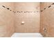 Tiled shower space features a mosaic tile accent stripe, soap dish, and chrome shower head at 1713 E Bonanza Rd, Las Vegas, NV 89101