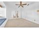 Bright bedroom features a ceiling fan and a charming window seat with cushion at 1951 Moyer Dr, Henderson, NV 89074