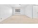 Well-lit bedroom features a window with a cushioned seat and neutral carpet at 1951 Moyer Dr, Henderson, NV 89074