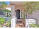 Inviting front entrance with a secure iron gate, tiled entryway, and well-maintained desert landscaping at 1951 Moyer Dr, Henderson, NV 89074