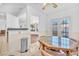 Bright breakfast nook features tile floors and a glass top table near the door to the backyard at 1951 Moyer Dr, Henderson, NV 89074