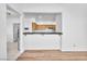 Bright kitchen area with counter seating open to the living room, wood cabinetry, and tile flooring at 1951 Moyer Dr, Henderson, NV 89074