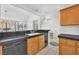 The kitchen and breakfast nook features a black countertop, wood cabinetry, tile floors, and modern appliances at 1951 Moyer Dr, Henderson, NV 89074