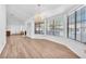 Bright living room features wood flooring, a fireplace, chandelier lighting, and lots of windows at 1951 Moyer Dr, Henderson, NV 89074