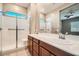 Bright bathroom featuring double sinks, a glass-enclosed shower, and white tile at 208 Coltrane Canyon Ave, Henderson, NV 89011