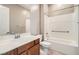 Bathroom with a shower-tub combination, vanity, and wood cabinetry at 208 Coltrane Canyon Ave, Henderson, NV 89011