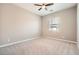 Bright bedroom featuring neutral paint, carpeted floors, and a modern ceiling fan at 208 Coltrane Canyon Ave, Henderson, NV 89011
