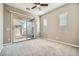 Bedroom with carpet, neutral paint, windows and access to the backyard at 208 Coltrane Canyon Ave, Henderson, NV 89011