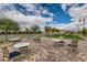 Scenic bocce ball court with tables, chairs, and lush landscaping at 208 Coltrane Canyon Ave, Henderson, NV 89011