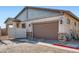 Charming home exterior with a two-car garage, low-maintenance landscaping, and inviting curb appeal at 208 Coltrane Canyon Ave, Henderson, NV 89011