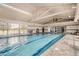 Indoor swimming pool with ample natural light and high ceilings, providing a serene aquatic environment at 208 Coltrane Canyon Ave, Henderson, NV 89011