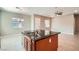 Spacious kitchen island with double sink, dark countertops, and view into adjacent living area at 208 Coltrane Canyon Ave, Henderson, NV 89011