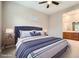 Staged bedroom with ensuite bathroom featuring plush bedding and soft, natural light at 208 Coltrane Canyon Ave, Henderson, NV 89011